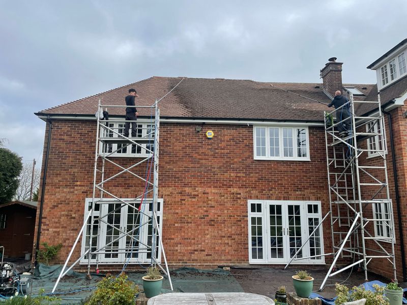Roof cleaning carried out safely from scaffold towers by The Roof Moss Cleaners in Guildford